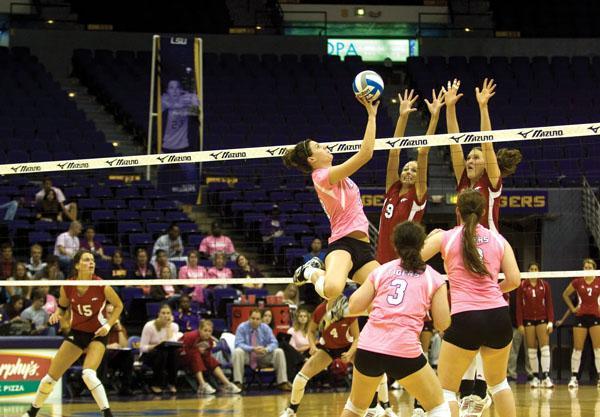 Sophomore Michelle Williams hits the over blockers ball during the Tigers&#8217; win against Arkansas on Oct. 16 in the PMAC.