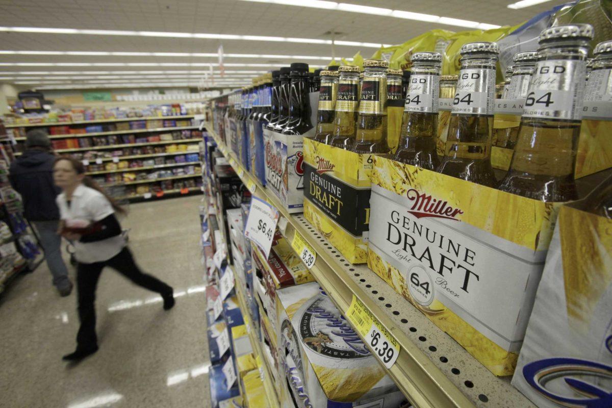 Bottles of Miller Genuine Draft 64 are seen at a grocery store on Oct. 27 in Des Moines, Iowa. The nation&#8217;s top brewers are trying to win over drinkers who want to swap beer guts for six-pack abs by putting new beers on a diet.