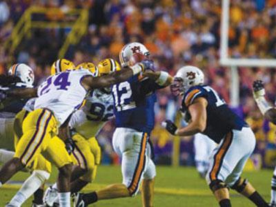 LSU senior linebacker Harry Coleman (24) and junior defensive tackle Drake Nevis (92) strip Auburn quarterback Chris Todd (12) of the ball during LSU&#8217;s 31-10 victory Saturday.