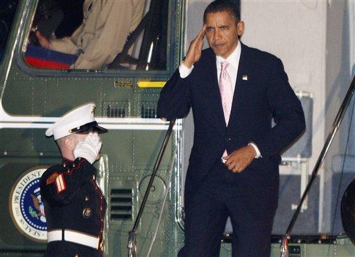 President Barack Obama returns a salute as he steps off Marine One helicopter on the South Lawn of the White House in Washington, Friday night, Oct. 23, 2009. Obama late on Friday declared the swine flu outbreak a national emergency and empowered his health secretary to suspend federal requirements and speed treatment for thousands of infected people.