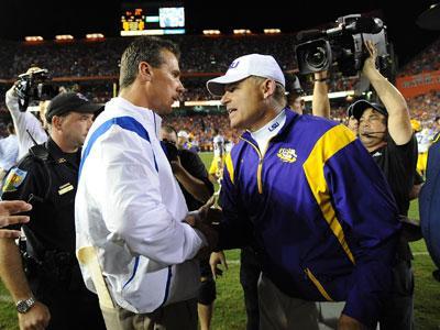 Florida coach Urban Meyer, left, shakes hands with LSU coach Les Miles, right, on Oct. 11, 2008, after the Gators beat the Tigers, 51-21, in Gainesville, Fla.