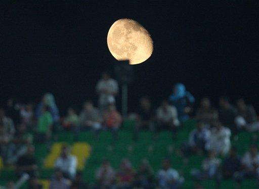 The moon rises over Mubarak stadium during an U-20 World Cup Round of 16 soccer match between Germany and Nigeria in the city of Suez, eastern Egypt, on Wednesday, Oct. 7, 2009.