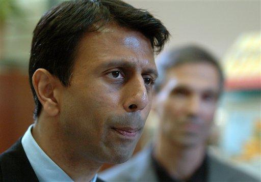 Gov. Bobby Jindal, left, talks about the flu season before receiving his flu shot, Wednesday, Sept. 30, 2009, at Teche Drugs in Lafayette, La. Looking on at the right is Rep. Fred Mills.