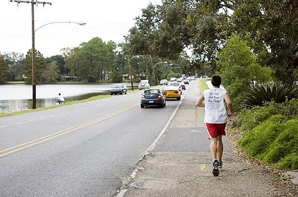 Chemical engineering freshman Jonathan Maurin runs the University lakes Monday. Maurin runs about five miles every afternoon to stay in shape.