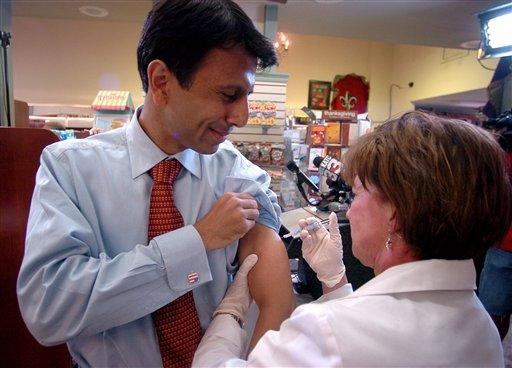 Gov. Bobby Jindal receives his seasonal flu shot from pharmacist Simone Ginn, right, at Teche Drugs in Lafayette, La., Wednesday, Sept. 30, 2009.