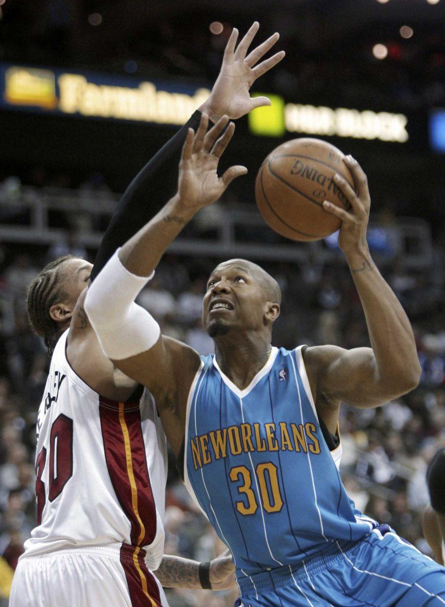 New Orleans Hornets forward David West (30) puts up a shot under pressure from Miami Heat forward Michael Beasley during a game Oct. 15 in Kansas City, Mo.