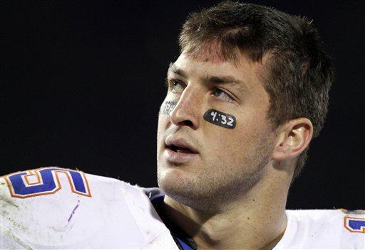 In this Oct. 24, 2009, file photo, Florida quarterback Tim Tebow watches a replay of his fourth-quarter interception that was returned for a touchdown by Mississippi State on the video scoreboard during an NCAA college football game in Starkville, Miss.