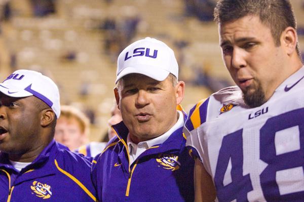 LSU coach Les Miles walks off the field with freshman linebacker Kellon Theriot after the Tigers&#8217; 42-0 victory against Tulane on Oct. 31.