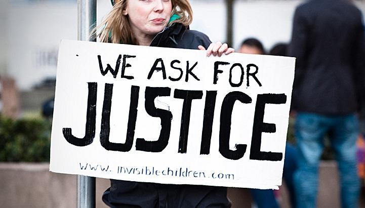 Activists display signs at an Invisible Children rally in London on April 25. People rallied together to raise awareness for child soldiers in Uganda.