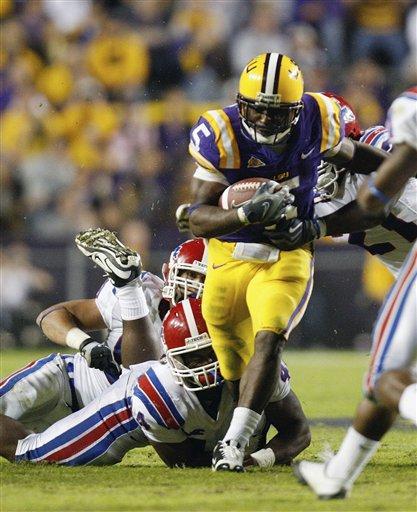 LSU running back Keiland Williams (5) steps away from Louisiana Tech safety Tank Calais (4) in the second half of an NCAA college football game in Baton Rouge, La., Saturday, Nov. 14, 2009. LSU defeated Louisiana Tech 24-16.