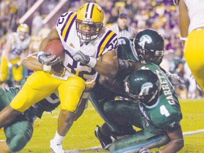 LSU senior running back Charles Scott (32) rushes in LSU&#8217;s win against Tulane in Tiger Stadium on Saturday.