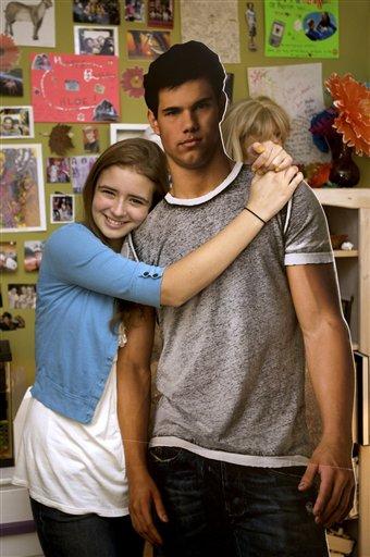 Teenage Twilight fan Chloe Bates,15, poses with a life-sized picture of Taylor Lautner in her room at her home in Los Angeles on Tuesday, Nov. 2, 2009. Chloe is in love with Lautner, one of the hunky stars of the "Twilight" films. And she's not alone.