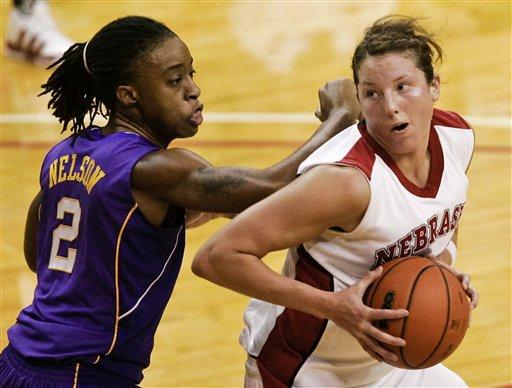 Nebraska's Kelsey Griffin goes against the defense of LSU's Jasmine Nelson in the second half of an NCAA college basketball game in Lincoln, Neb., Sunday, Dec. 20, 2009. Nebraska beat LSU 77-63.