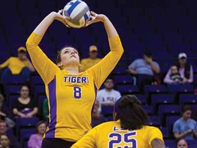 LSU senior setter Sam Dabbs (8) sets up senior middle blocker Brittnee Cooper (25) for a kill during the Tigers&#8217; 3-0 victory Nov. 20 against Mississippi State in the PMAC. Cooper was named Southeastern Conference Player of the Year, and Dabbs was awarded with a spot on the All-SEC First Team.