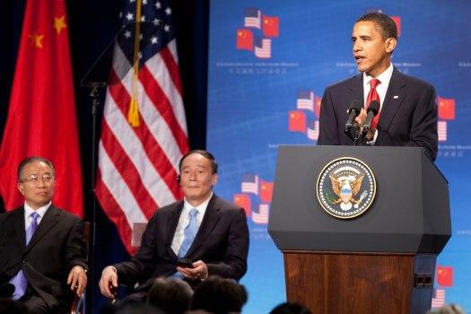 President Barack Obama addresses the opening session of the first U.S.-China Strategic and Economic Dialogue at the Ronald Reagan Building and International Trade Center in Washington, Monday, July 27, 2009. Listening at left are Chinese Vice Premier Wang Qishan, center, and Chinese State Councilor Dai Bingguo, left.
 