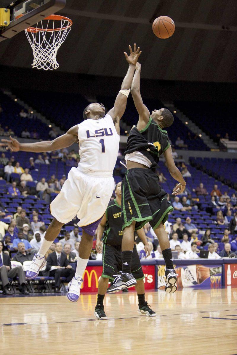 LSU senior forward Tasmin Mitchell (1) fights for the offensive rebound Monday night against Southeastern junior forward Jason Marks, right, during the Tigers&#8217; 77-60 win against the Lions in the PMAC. Mitchell grabbed a career-high 18 rebounds in the game.