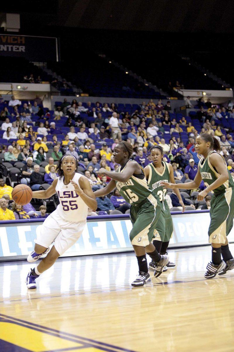 LSU sophomore forward LaSondra Barrett (55) drives to the basket Tuesday night against Southeastern junior forward Rashima Jenkins (15) during the Lady Tigers' 72-27 win against the Lady Lions in the PMAC. Barrett picked up her first double-double of the season with 11 points and 10 rebounds.