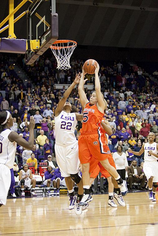 Auburn junior guard Alli Smalley (5) brings down the rebound Sunday after LSU sophomore guard Destini Hughes missed a last-second, wide-open layup to beat LSU, 64-62, in overtime in the PMAC.