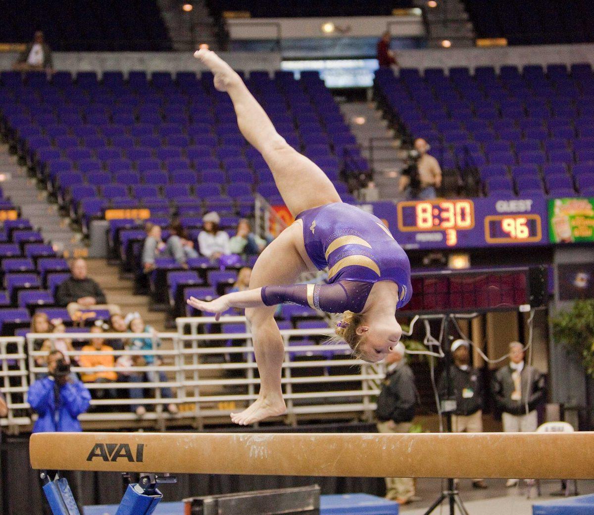 LSU senior Susan Jackson flips on the beam Friday during the Tigers' 194.375-190.625 win against Maryland in the PMAC. Jackson scored a 9.700 on the beam and won first place all-around.