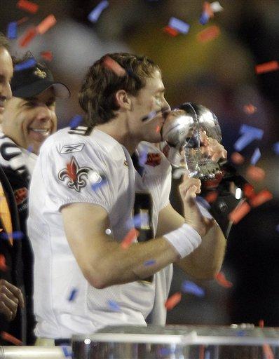 New Orleans Saints quarterback Drew Brees (9) celebrates with the Vince Lombardi trophy after the NFL Super Bowl XLIV football game against the Indianapolis Colts in Miami, Sunday, Feb. 7, 2010. The Saints won 31-17.