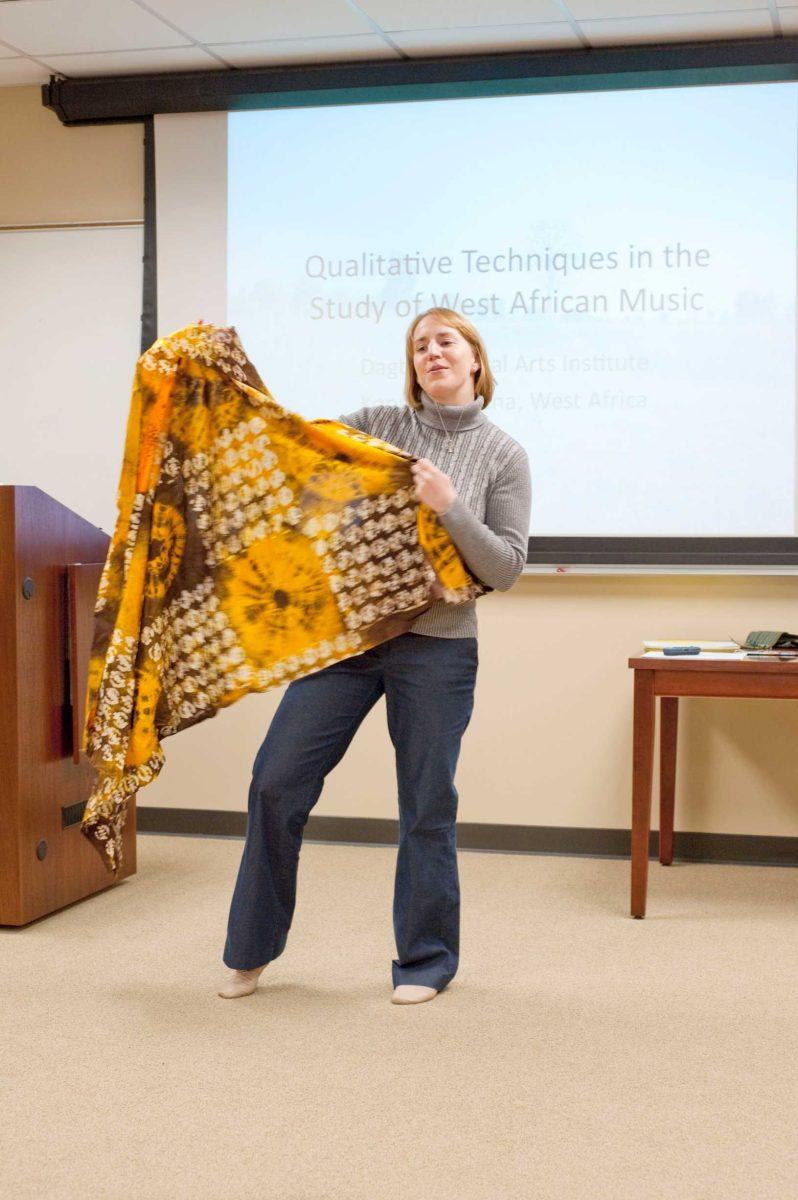 Sara McCall, music graduate student, presents a Kente cloth she got on safari during her six weeks studying abroad in Africa.