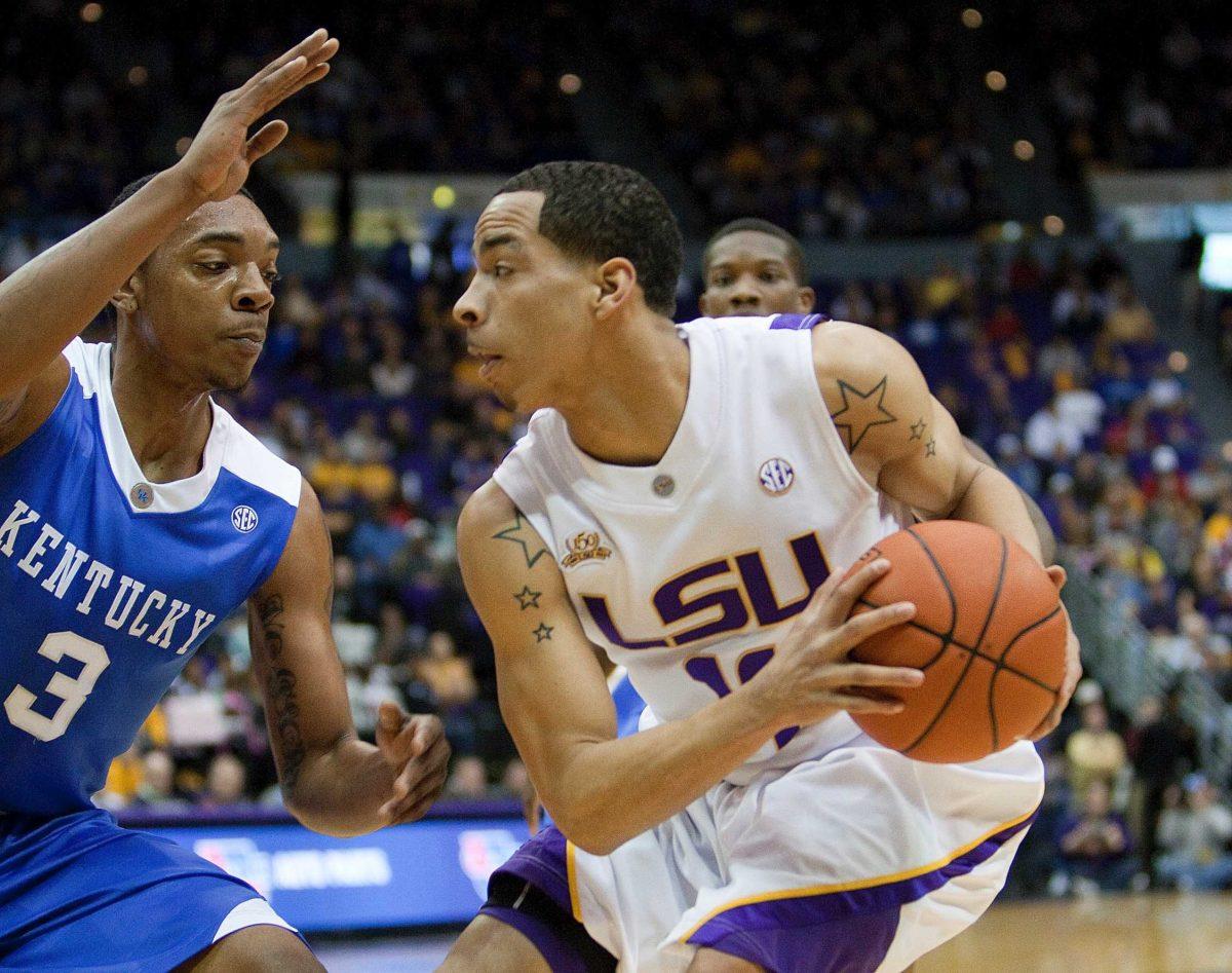 LSU junior guard Bo Spencer (11) tries to work around Kentucky sophomore guard Darnell Dodson (3) during the Tigers&#8217; 81-55 loss Feb. 6 in the PMAC.