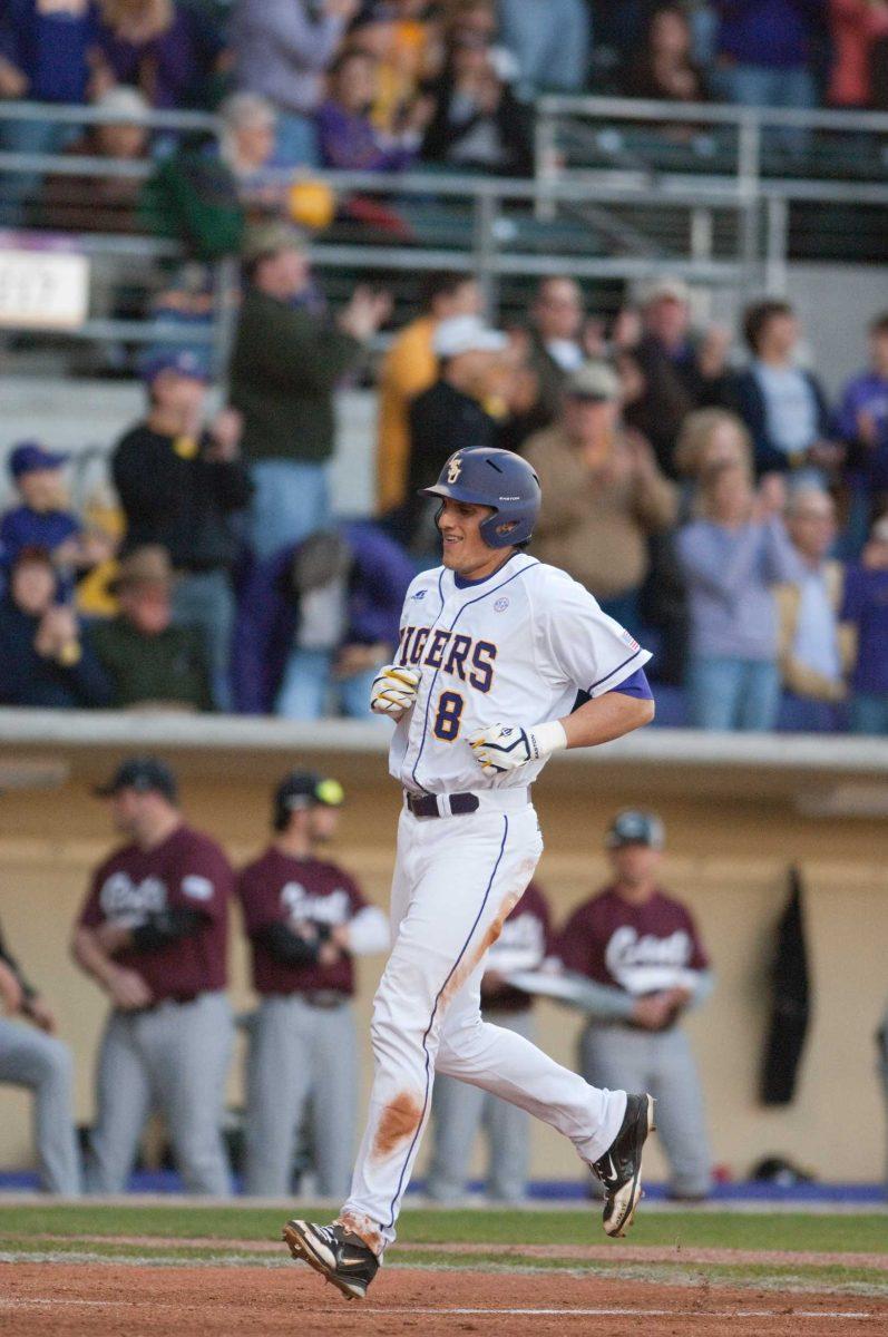 <p>LSU sophomore outfielder Mikie Mahtook (8) runs in to the dugout after an at-bat during LSU’s 25-8 win against Centenary on Feb. 20.</p>