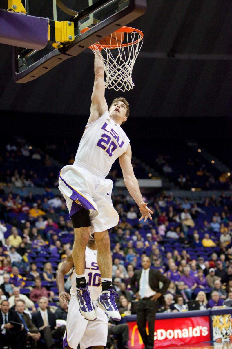 LSU sophomore guard Zach Kinsley dunks the ball Feb. 24 during the Tigers&#8217; win against Arkansas. Kinsley is one of four walk-ons who will have to try out again.