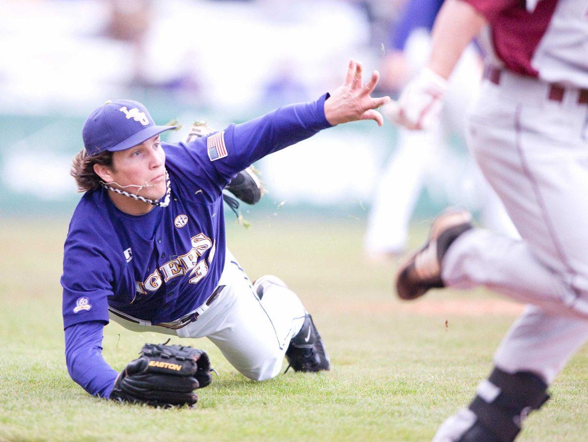 LSU sophomore pitcher Chris Matulis (30) throws the ball to first after a bunt against Arkansas on Mar. The Tigers won 5-1.