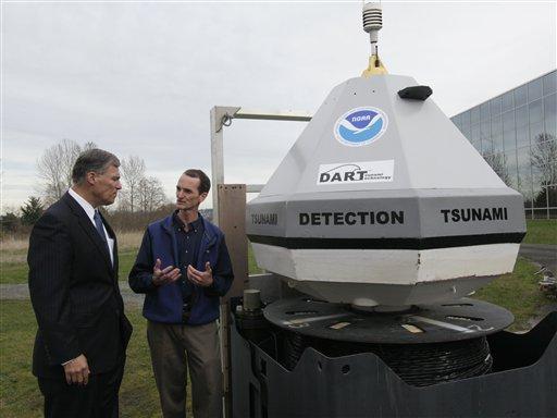 Rep. Jay Inslee, D-Wash., left, looks at a buoy used to detect tsunami waves as he talks with Christian Meinig, director of the engineering development division of the National Oceanic and Atmospheric Administration Pacific Marine Environmental Laboratory in Seattle on Monday, March 1, 2010. The buoys were developed by NOAA to be smaller and easier to deploy than current buoys, and they are capable of recording even very small tsunami waves, which can aid in predicting more-destructive events.