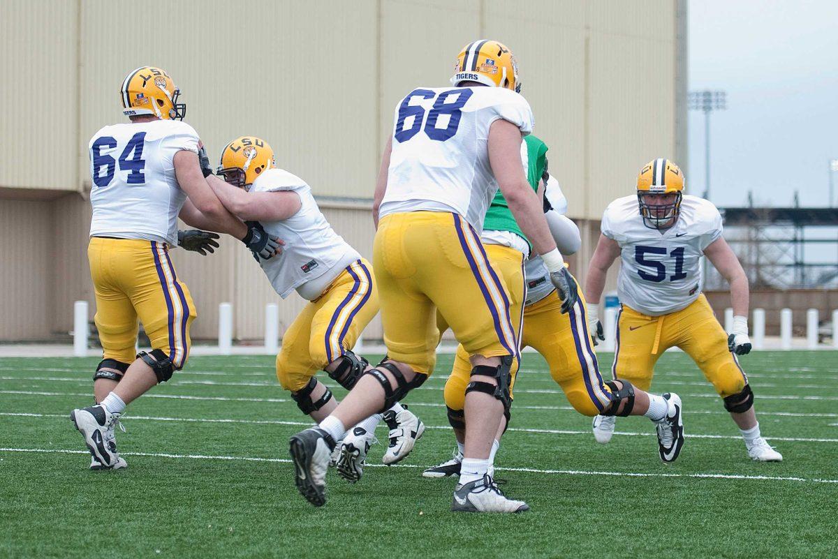 LSU sophomore center Patrick Lonergan (64) and junior offensive guard Josh Dworaczyk (68) work on blocking drills during practice Tuesday, March 16, 2010, at the Charles McClendon Practice Facility.