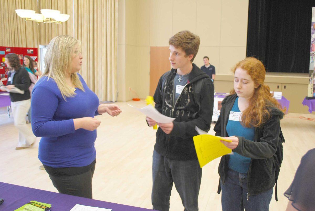 Benjamin McConnell, Computer Engineering Freshman, middle, and Emily McConnel, Plant and Soil Systems Junior, right, speak to Lane Fryou, LSU UREC representative Thursday afternoon at he Career Services Job Fair in the Cotillion Ballroom.