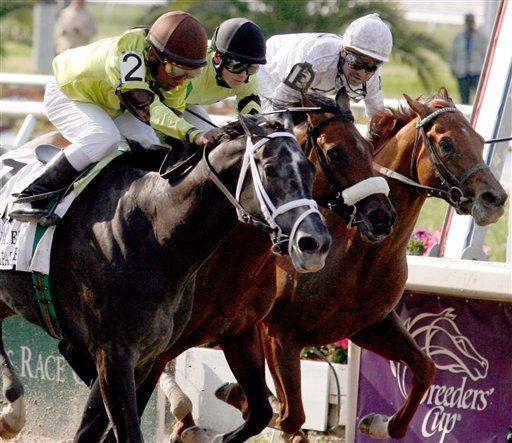 Mission Impazible, left, ridden by Rajiv Maragh wins the Louisiana Derby horse race on Saturday, March 27, 2010, at the Fair Grounds in New Orleans.