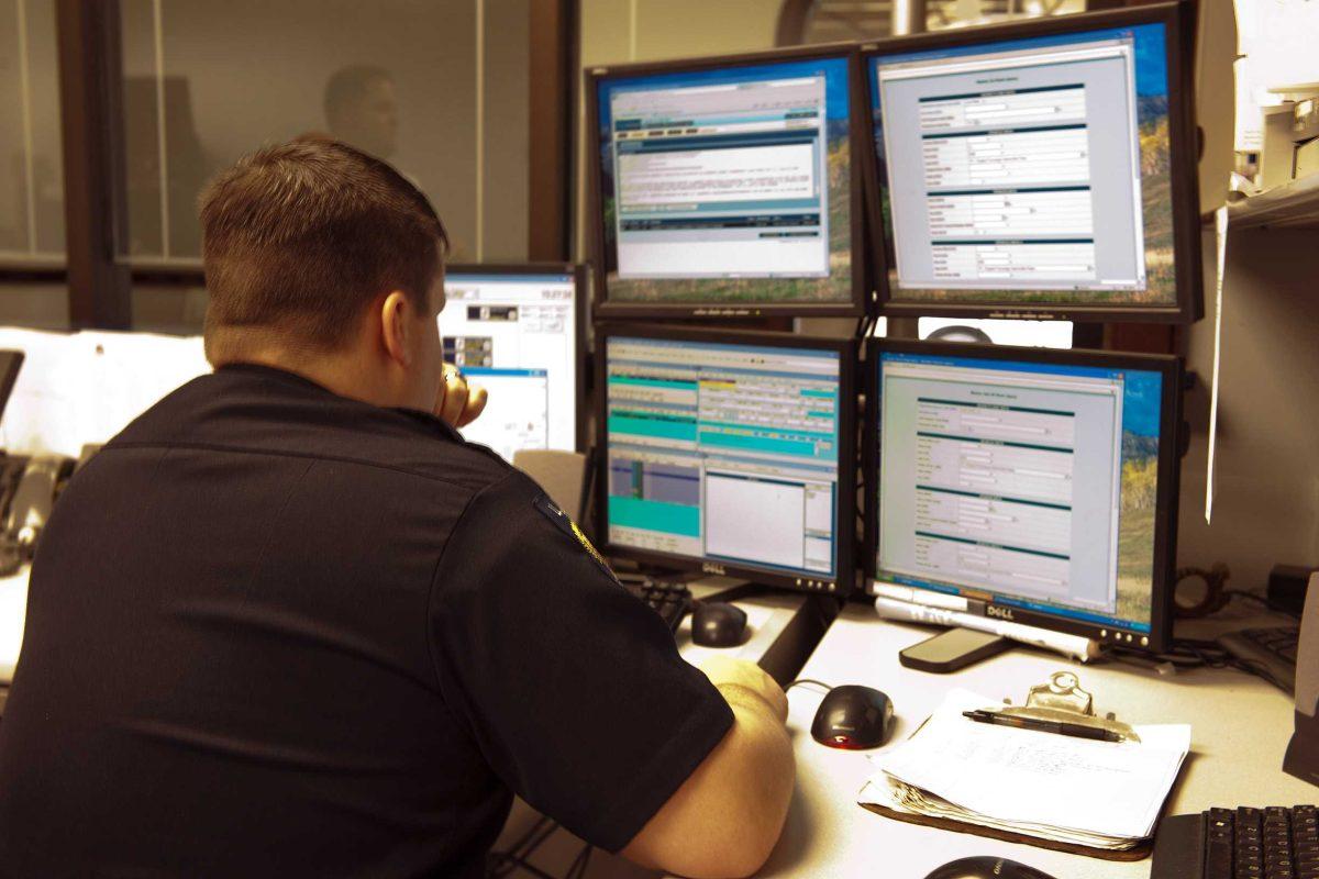 Clay Cain, LSUPD officer, monitors the National Crime Information Center database in the LSUPD office located in the Public Safety Building.