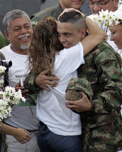 Relatives welcome hostage Pablo Moncayo, center, as he arrives to the airport in Florencia in southern Colombia after being released by rebels of the Revolutionary Armed Forces of Colombia, FARC, Tuesday, March 30, 2010. Sgt. Moncayo was kidnapped after a rebel attack on a military mountaintop communications post in Dec. 1997. At left, Moncayo's father, Gustavo Moncayo.