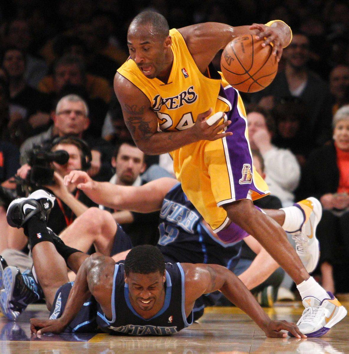 Los Angeles Lakers&#8217; Kobe Bryant, right, grabs a loose ball over Utah Jazz player Wesley Matthews during an NBA basketball game in Los Angeles on April 2.