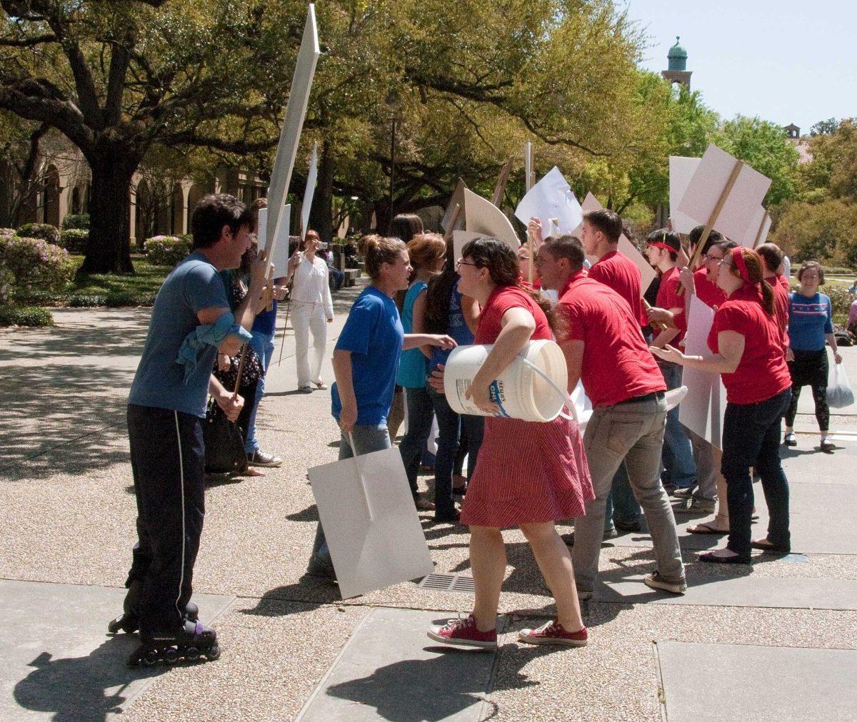 Students confront each other in a mock protest Wednesday in the Quad for a performance art class. The event was intended to satirize the debate system.