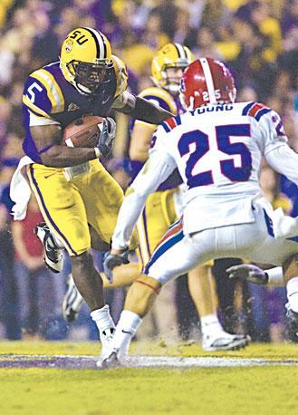 Former LSU running back Keiland Williams, left, tries to dodge a Louisiana Tech defender Nov. 14. Williams is projected to be a late-round draft pick this weekend.