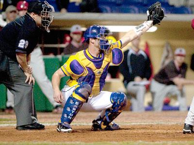 Gibbs puts his glove up for a wild pitch March 5 during the Tigers&#8217; 13-7 win against Brown.