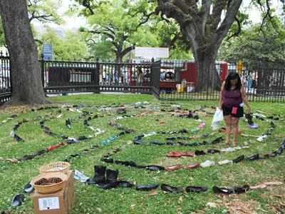 A labyrinth of free shoes is laid out Sunday to promote recycling instead of wasting during the Earth Day celebration downtown.