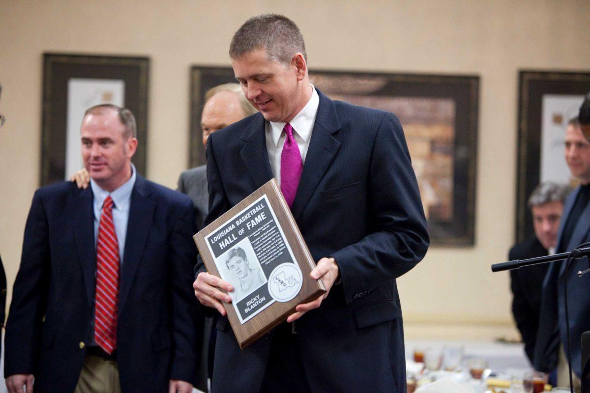 Former LSU forward Ricky Blanton holds up his plaque Saturday after being inducted into the Louisiana Basketball Hall of Fame during the annual Louisiana Association of Basketball Coaches banquet at Embassy Suites Hotel.