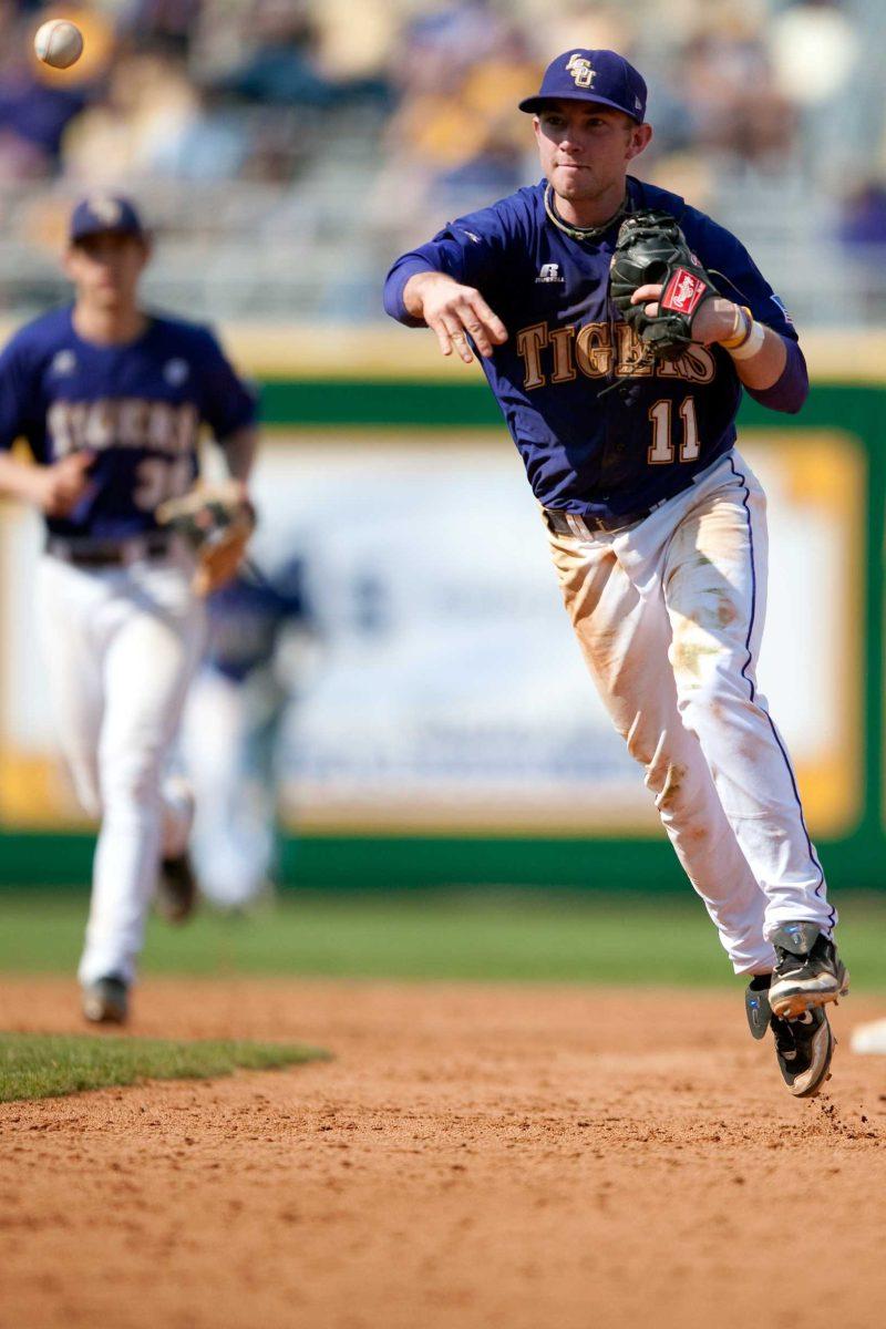 LSU sophomore second baseman Tyler Hanover (11) throws the ball to first base March 7 during the Tigers&#8217; 9-2 victory against Brown at Alex Box Stadium.