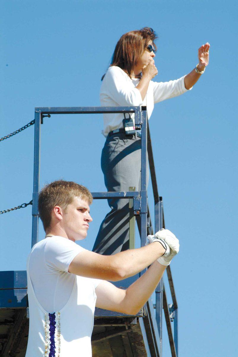 Linda Moorhouse directs the band from the top of a ladder.