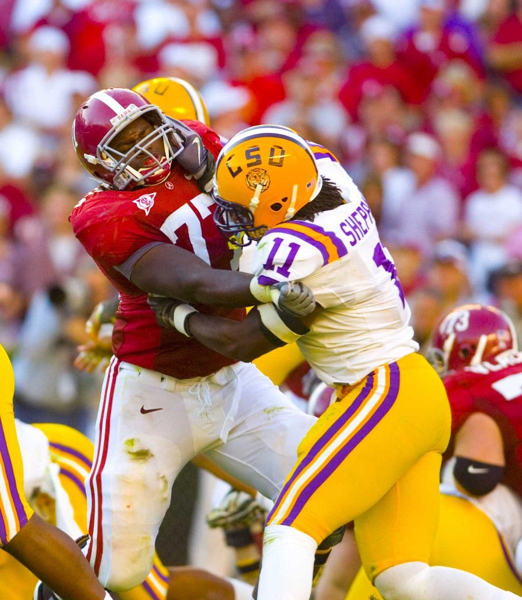 LSU senior middle linebacker Kelvin Sheppard (11) fights off Alabama offensive lineman James Carpenter (77) in the Tigers&#8217; 24-15 loss Nov. 7 against the Crimson Tide in Bryant-Denny Stadium.