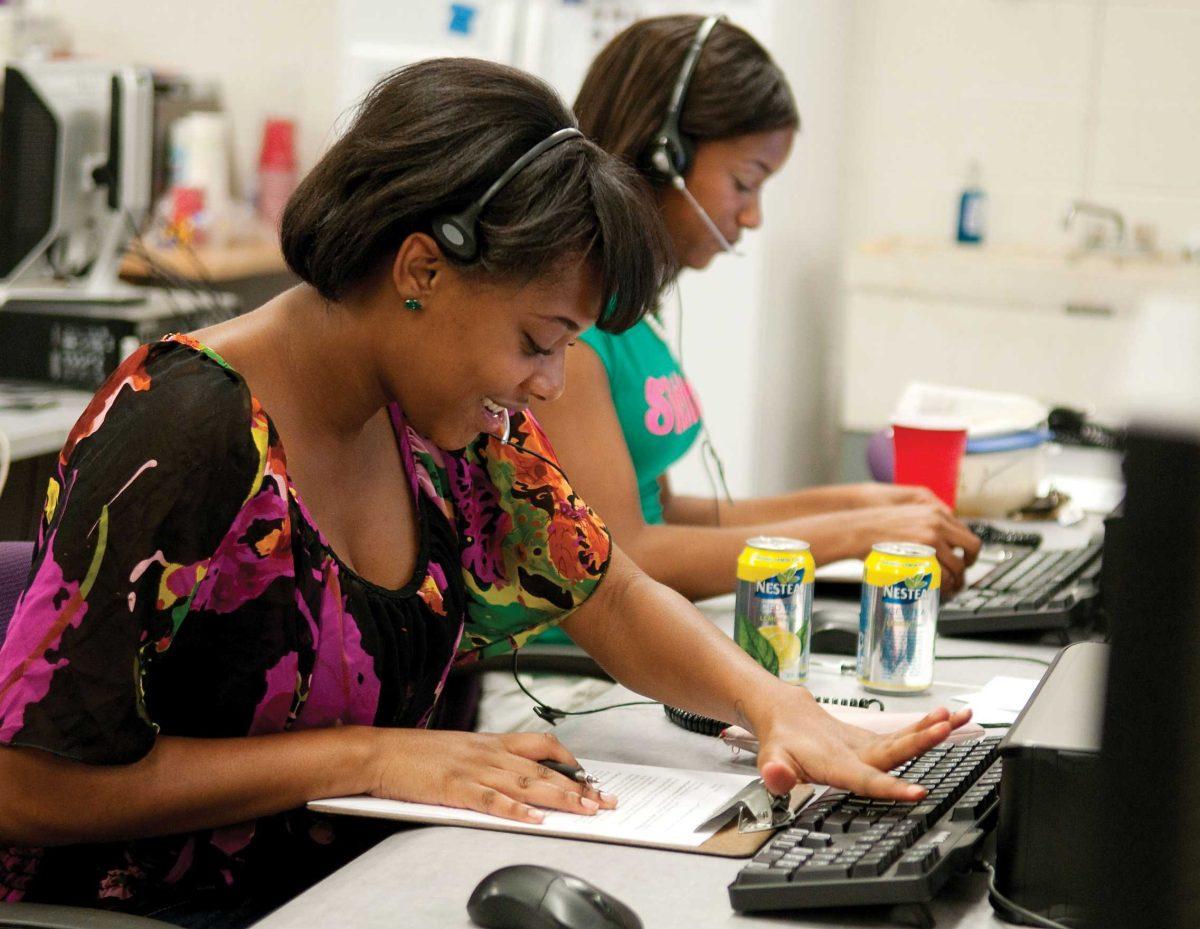 Junior Cornetta Mosley, left, and senior Keyley Mable make calls Monday to University alumni while working for Tiger Talk.