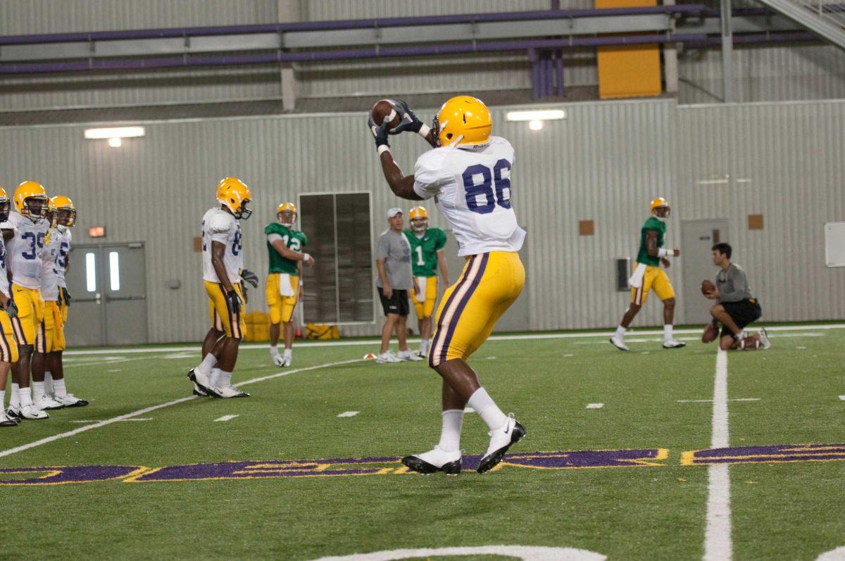 New passing game coordinator and wide receivers coach Billy Gonzales works with an LSU receiver during fall practice at LSU&#8217;s indoor facility.