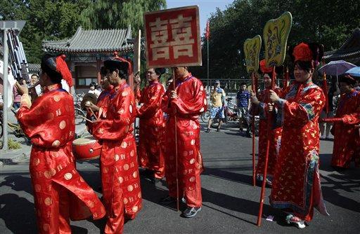 A wedding procession with a traditional Chinese theme march on a street of Beijing, China, Sunday, Sept. 12, 2010.