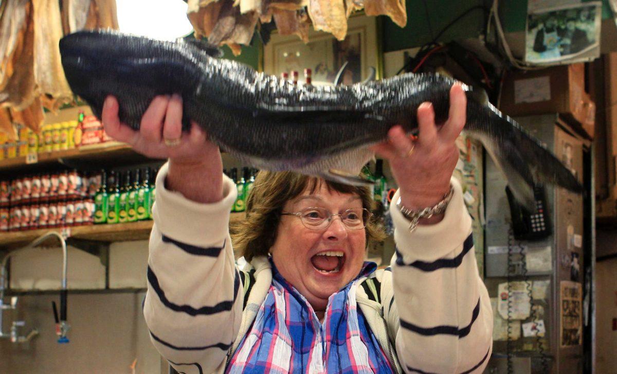 Linda Hunter lifts a salmon after catching it Monday in Seattle. The chum salmon is not sold in markets, but used for tourists who want to experience fish tossing.