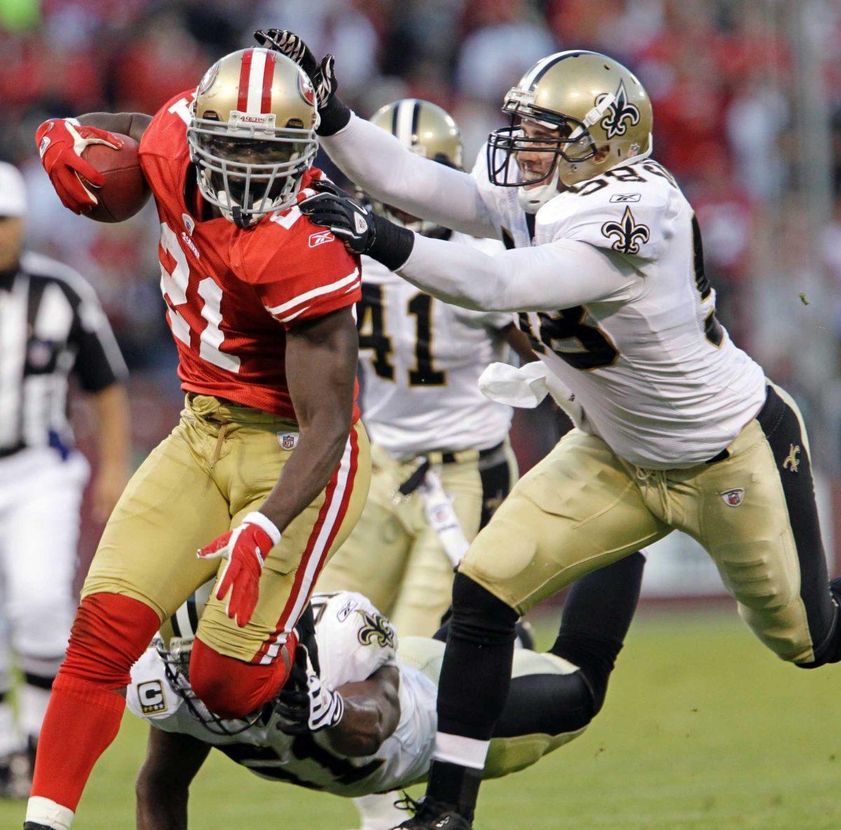 San Francisco 49ers running back Frank Gore tries to escape New Orleans Saints linebacker Scott Shale on Monday during the Saints&#8217; 25-22 win against the 49ers.