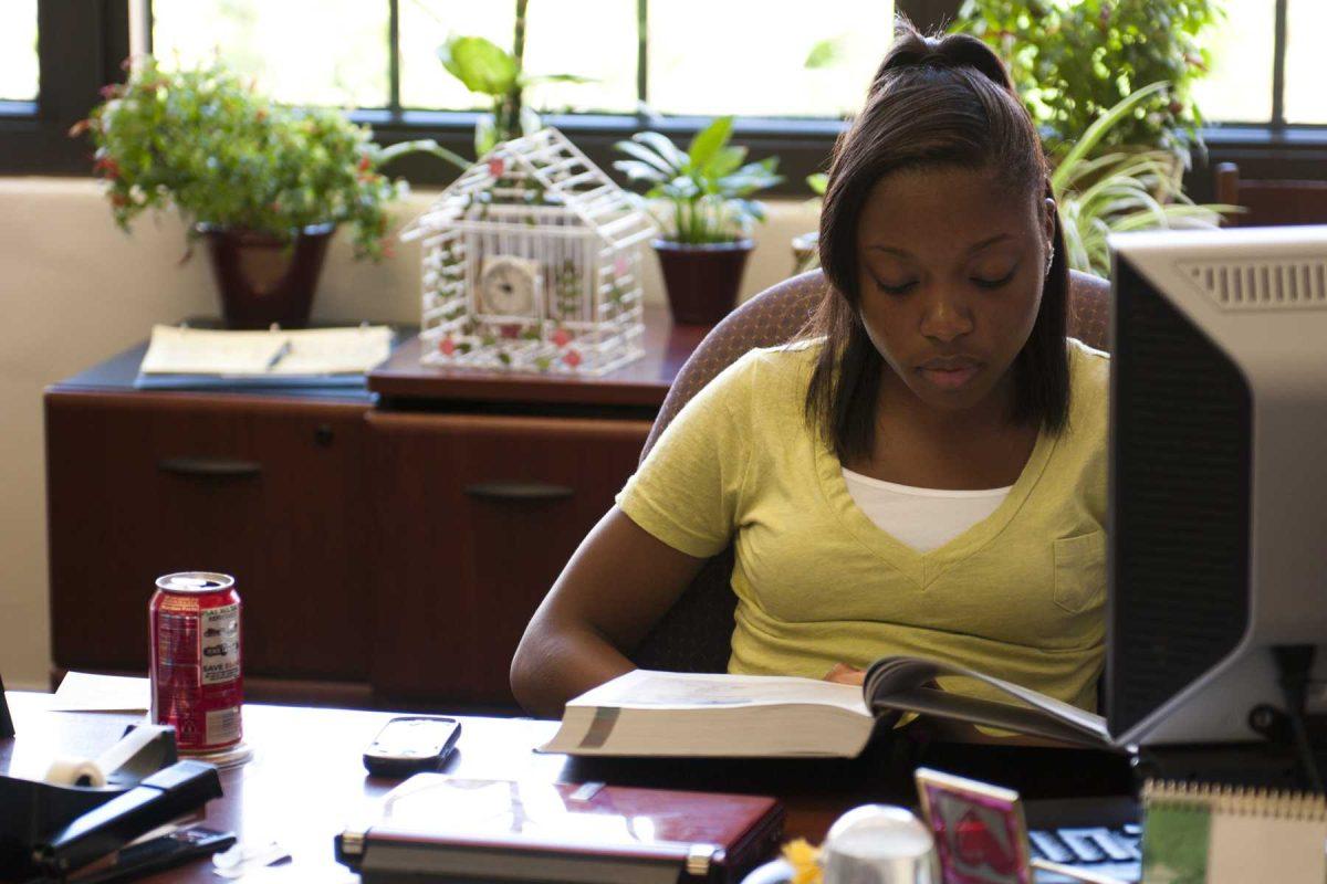 Danielle Webb, psychology freshman, is busy at her work-study job in Audubon Hall.